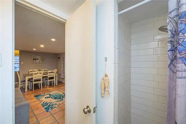 a living room with furniture a rug and a dining table