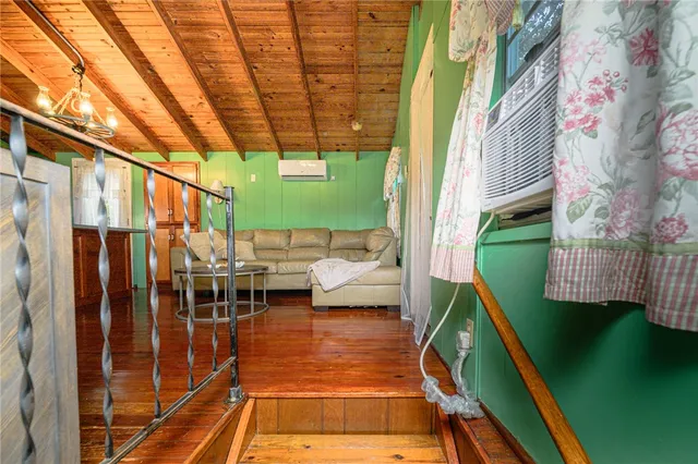 a dining room with furniture and a flat screen tv