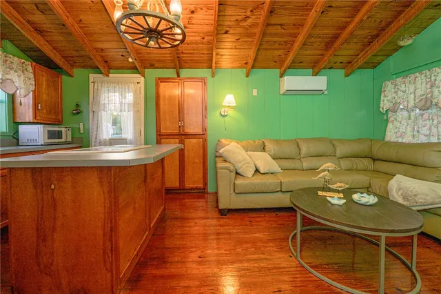 a bedroom with a bed a dresser and a book shelf