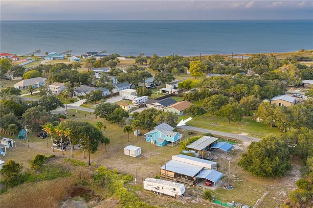 an aerial view of a house with a ocean view