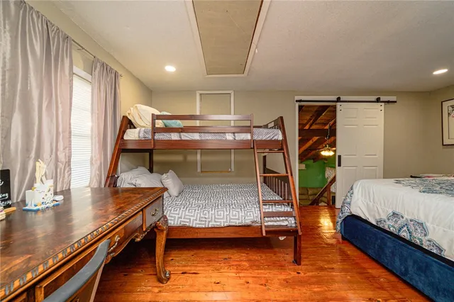 a bedroom with a bed and a lamp on table