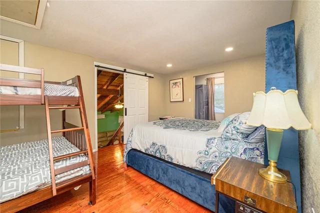 a large bathroom with a tub a sink and a large mirror