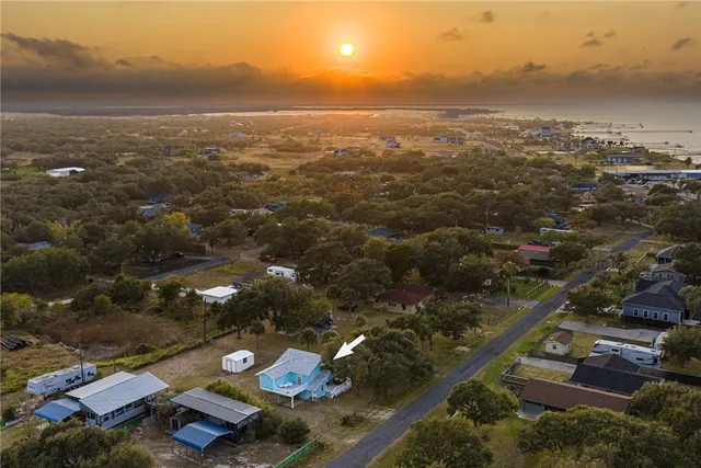 an aerial view of a backyard with table and chairs