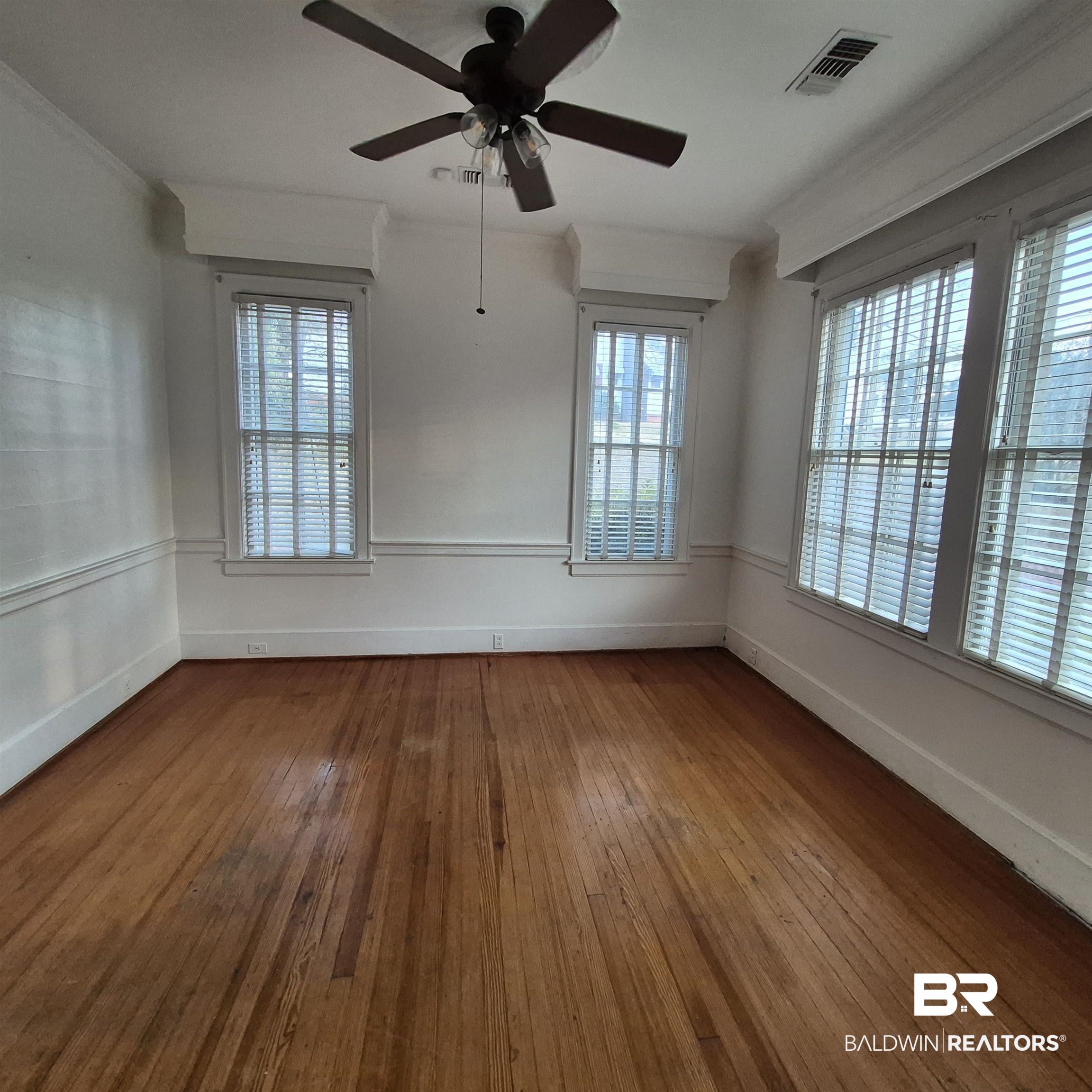 308 Rural Street Evergreen, AL 36401 - Photo 9 of 40 Unfurnished room with hardwood / wood-style floors and a ceiling fan