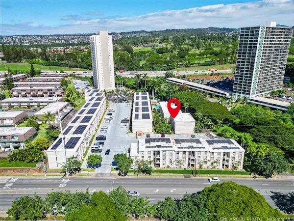 a aerial view of multi story residential apartment building with a yard