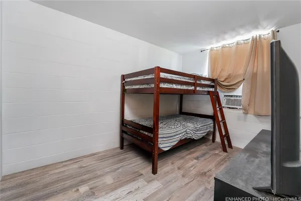 a bedroom with a bunk bed and a dresser