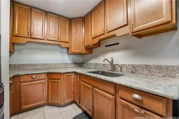 a kitchen with granite countertop cabinets sink and stainless steel appliances