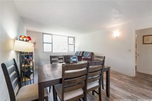 a view of a dining room with furniture window and wooden floor