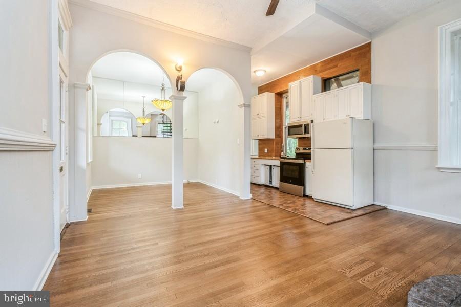 16 Railroad Place Pennington, NJ 08534 - Photo 3 of 14 a view of a kitchen with a refrigerator and a stove top oven
