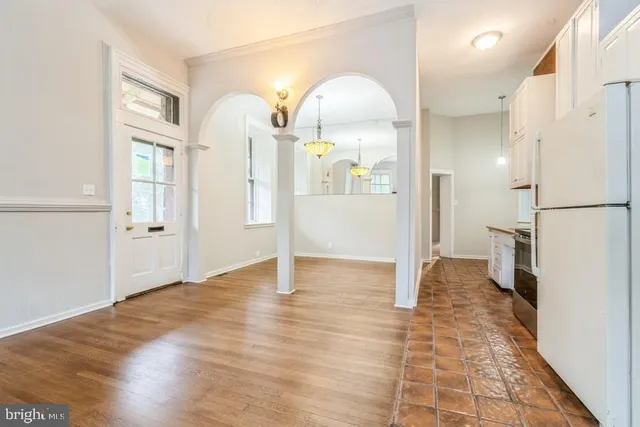 a view of empty room with wooden floor