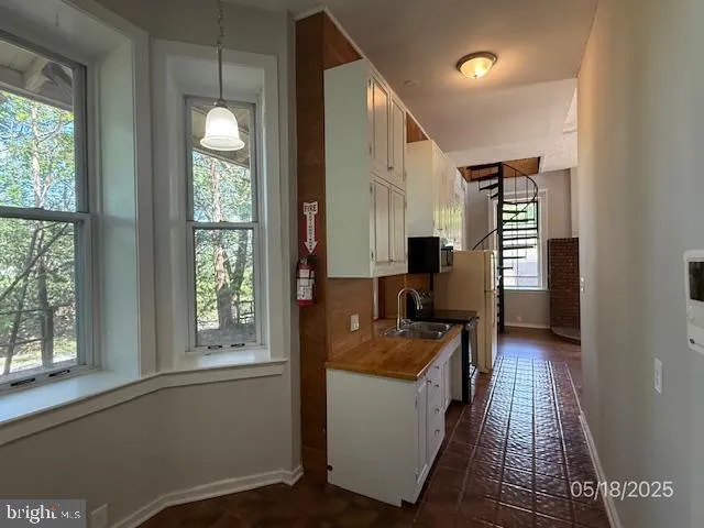 a kitchen with sink refrigerator and window