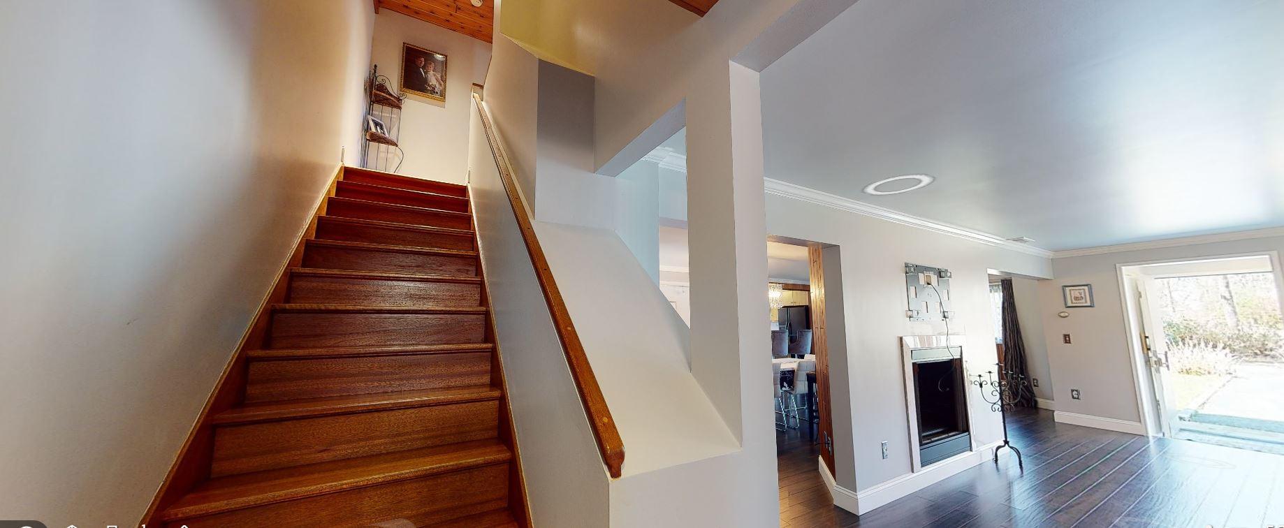 149 Wheeler Road Mashpee, MA 02649 - Photo 16 of 41 a view of entryway with wooden floor and stairs
