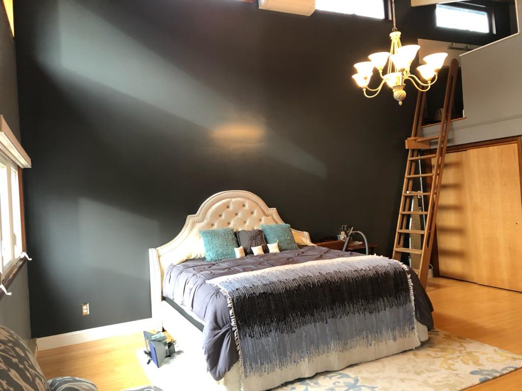 149 Wheeler Road Mashpee, MA 02649 - Photo 20 of 41 a bedroom with a bed and a chandelier