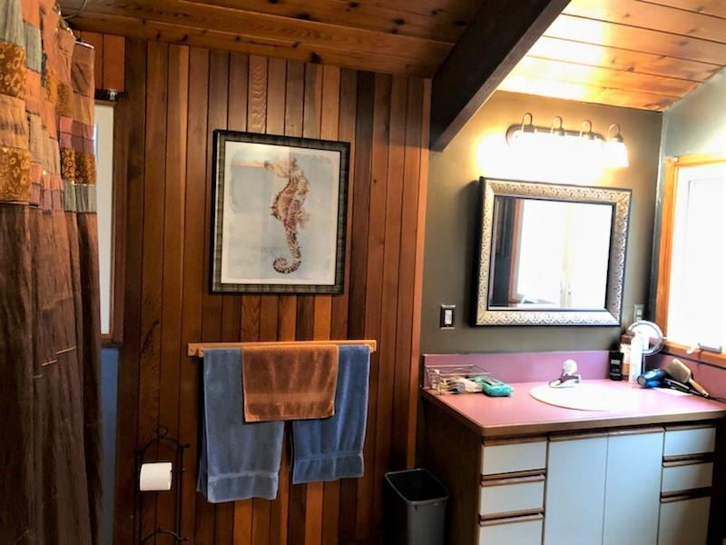 149 Wheeler Road Mashpee, MA 02649 - Photo 28 of 41 a bathroom with a sink a mirror and a window