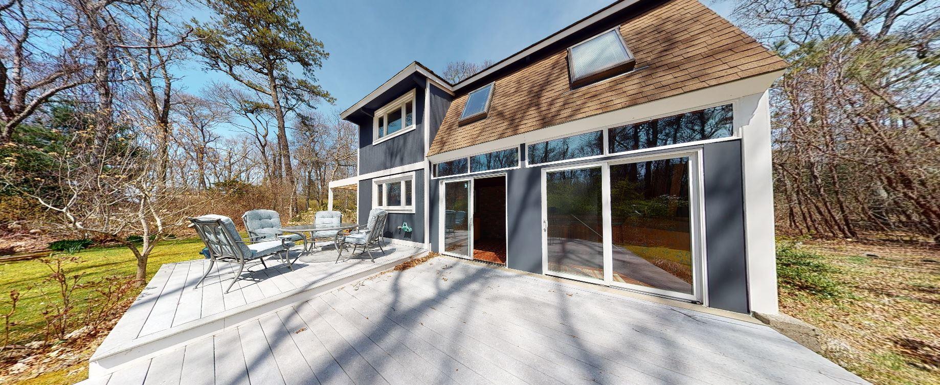 149 Wheeler Road Mashpee, MA 02649 - Photo 29 of 41 a view of a house with backyard and sitting area