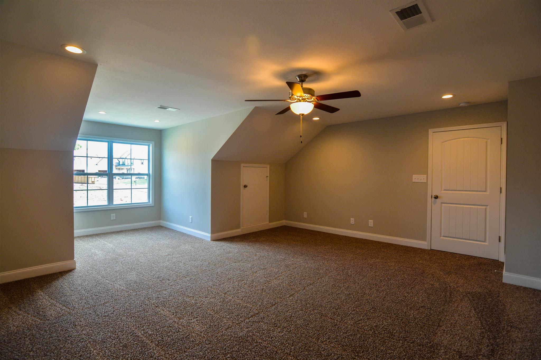 780 Grays Chapel Road Southside, TN 37171 - Photo 20 of 30 an empty room with a chandelier fan and windows