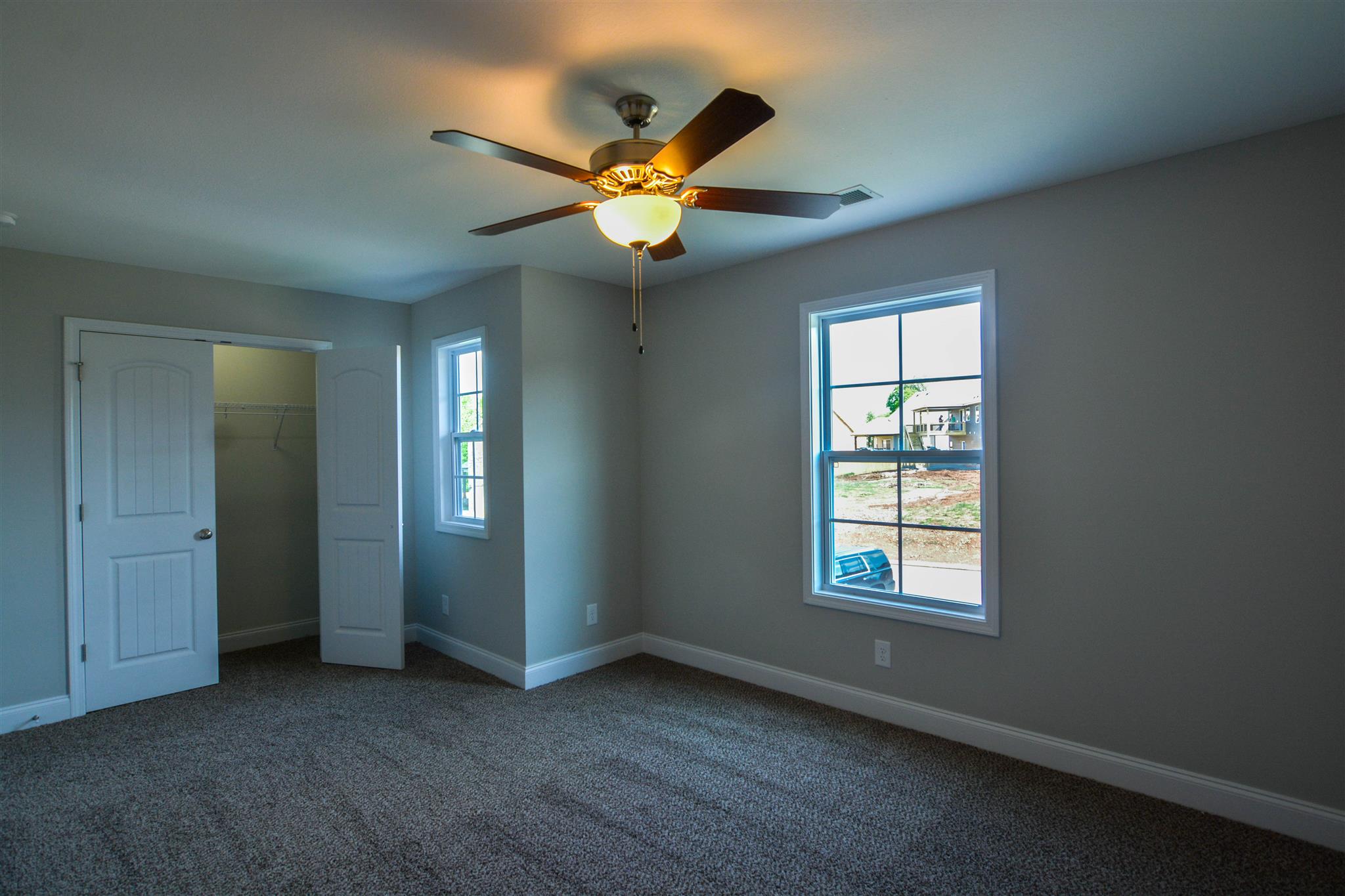 780 Grays Chapel Road Southside, TN 37171 - Photo 22 of 30 an empty room with windows and fan