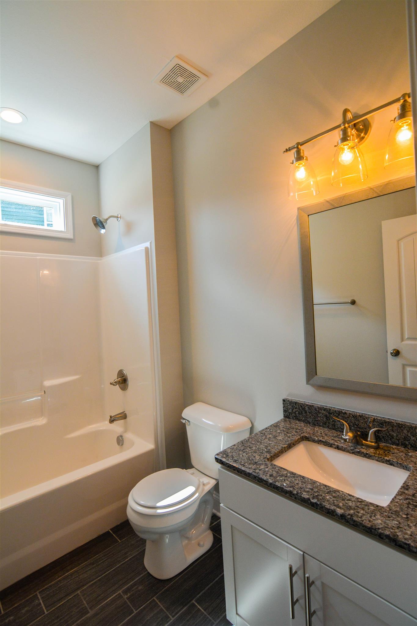 780 Grays Chapel Road Southside, TN 37171 - Photo 28 of 30 a bathroom with a granite countertop sink toilet and shower