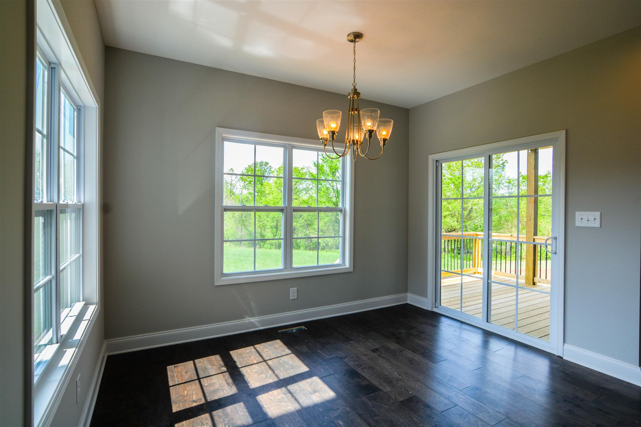 780 Grays Chapel Road Southside, TN 37171 - Photo 9 of 30 a view of an empty room with wooden floor chandeliers and kitchen view