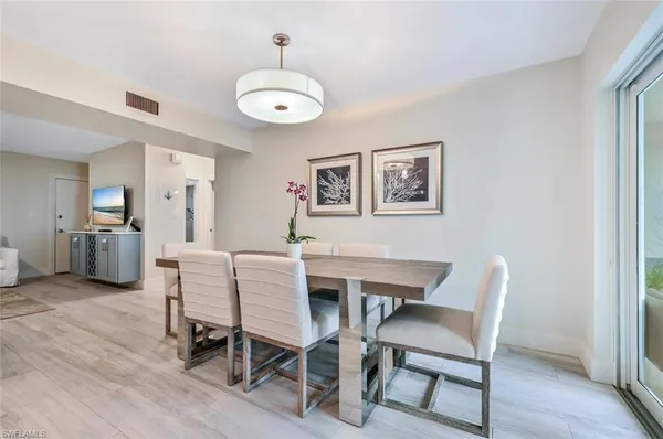 a view of a dining room with furniture wooden floor and a chandelier