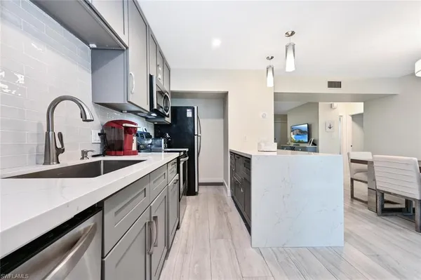 a kitchen with stainless steel appliances a sink and a stove