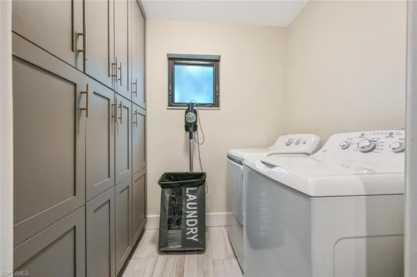 a bedroom with a bed and painting on the wall