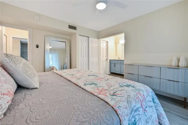 a spacious bedroom with a bed and a table