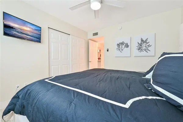 a bathroom with a granite countertop sink a mirror and shower