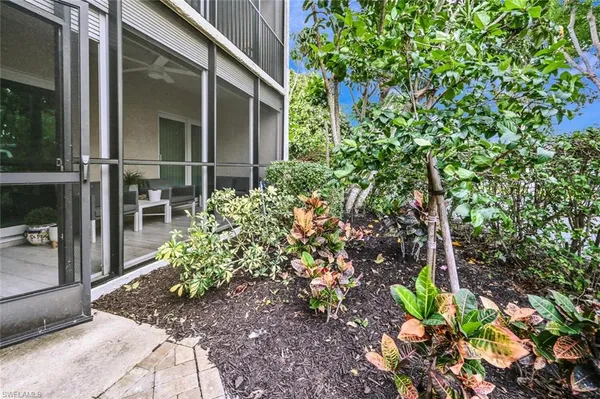 a view of a house with a backyard porch and sitting area