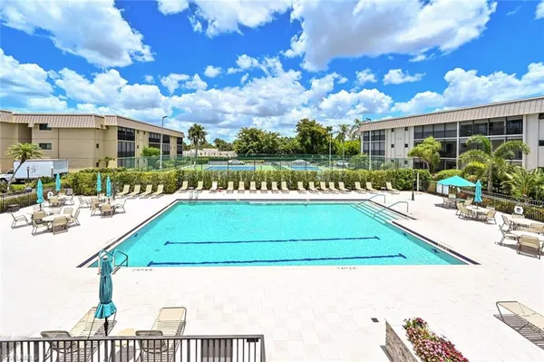 a view of a swimming pool with a yard