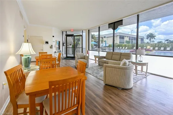 a view of a living room with furniture and floor to ceiling windows