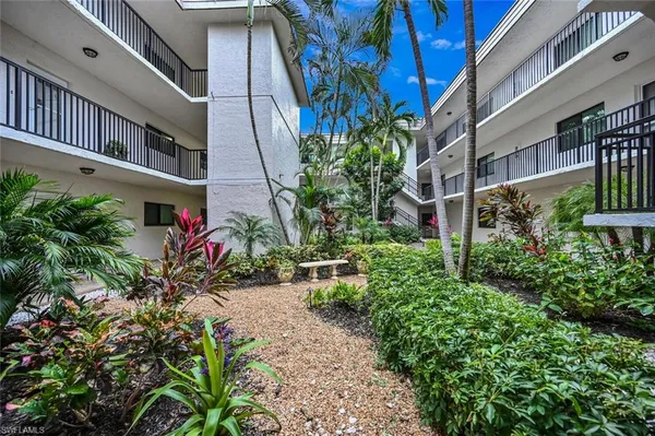 a view of a garden with a house