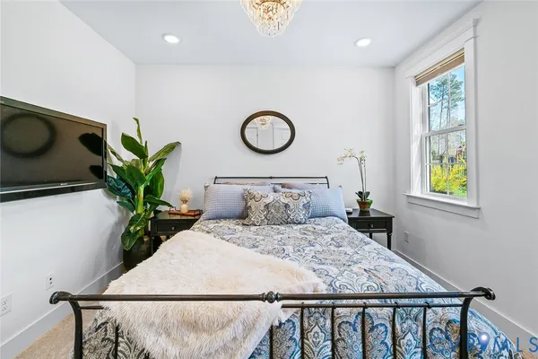 a spacious bedroom with a bed and large window