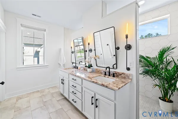 a bathroom with a sink vanity and a mirror