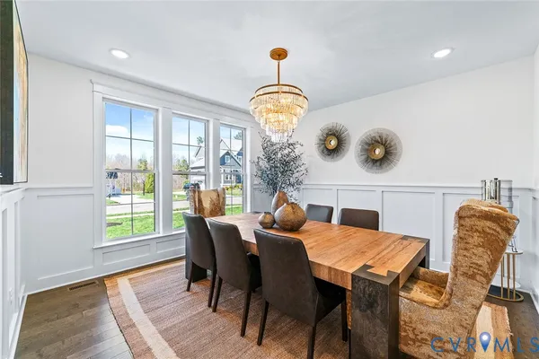 a open kitchen with kitchen island white cabinets and refrigerator