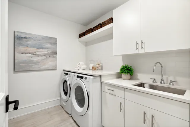 a utility room with sink dryer and washer