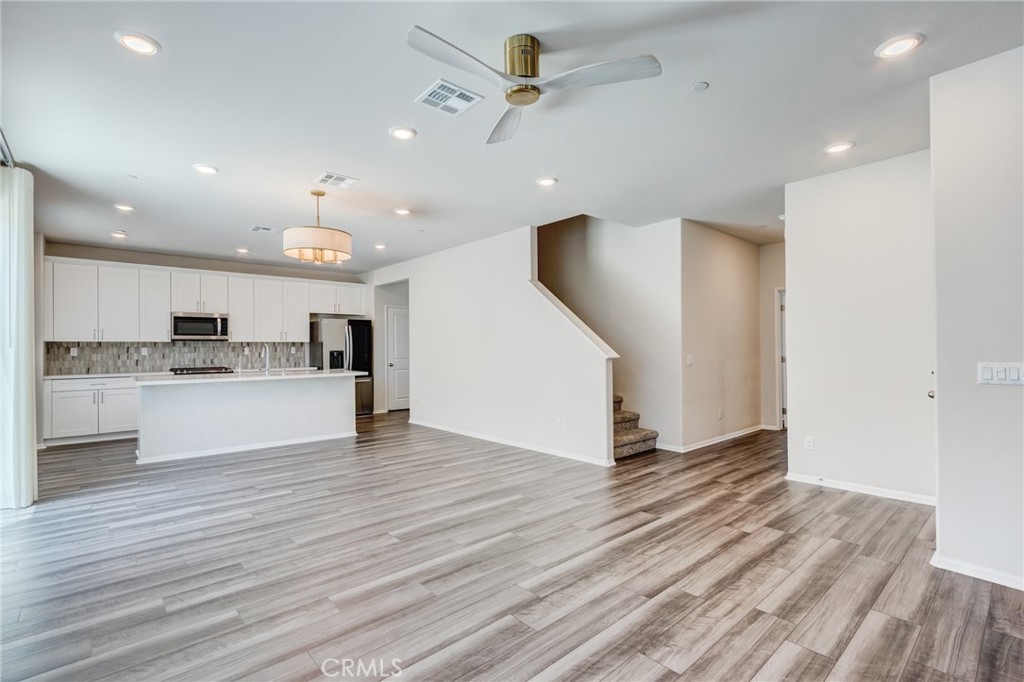 36469 Shine Drive Winchester, CA 92596 - Photo 16 of 73 a view of kitchen with cabinets and wooden floor