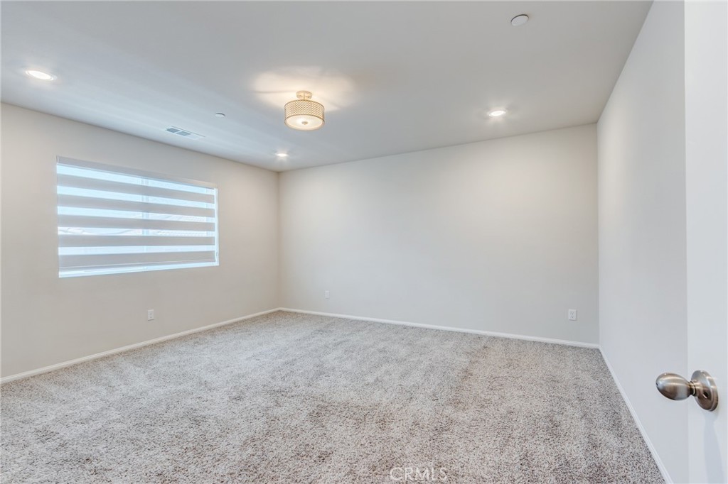36469 Shine Drive Winchester, CA 92596 - Photo 19 of 73 an empty room with windows and ceiling fan