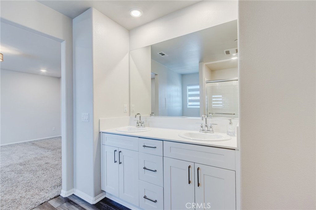 36469 Shine Drive Winchester, CA 92596 - Photo 22 of 73 a bathroom with a double vanity sink and mirror