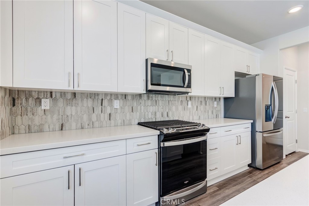 36469 Shine Drive Winchester, CA 92596 - Photo 4 of 73 a kitchen with stainless steel appliances a stove microwave and refrigerator