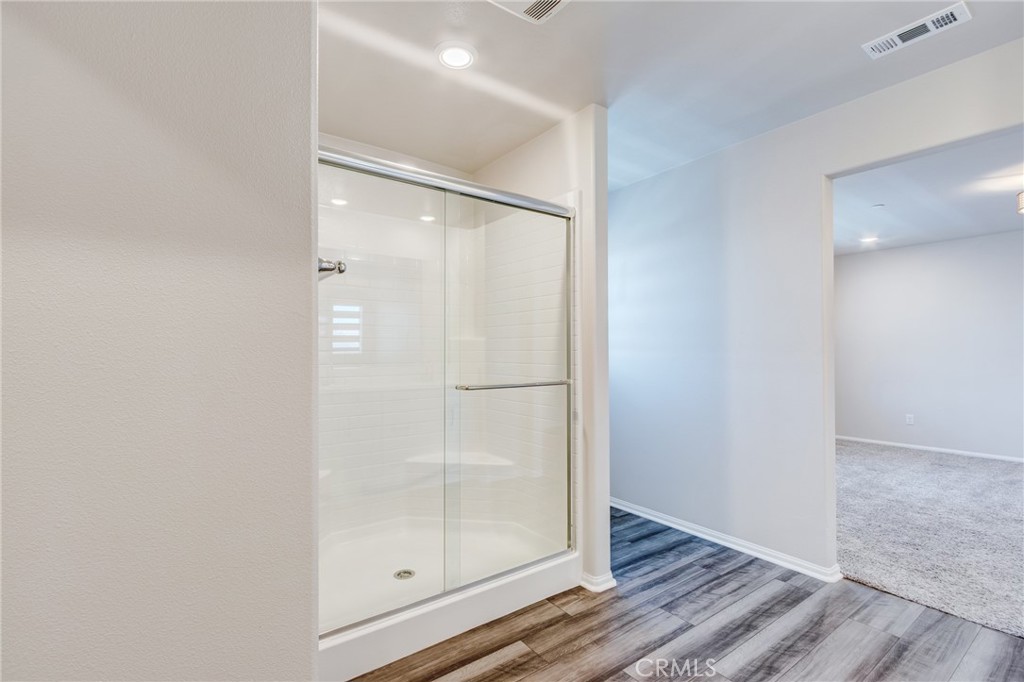 36469 Shine Drive Winchester, CA 92596 - Photo 54 of 73 a bathroom with a glass shower door