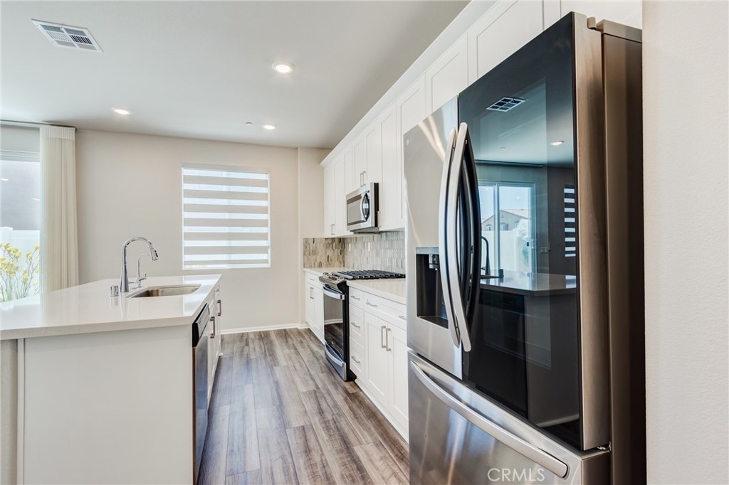 36469 Shine Drive Winchester, CA 92596 - Photo 6 of 73 a kitchen with granite countertop a refrigerator stove and sink