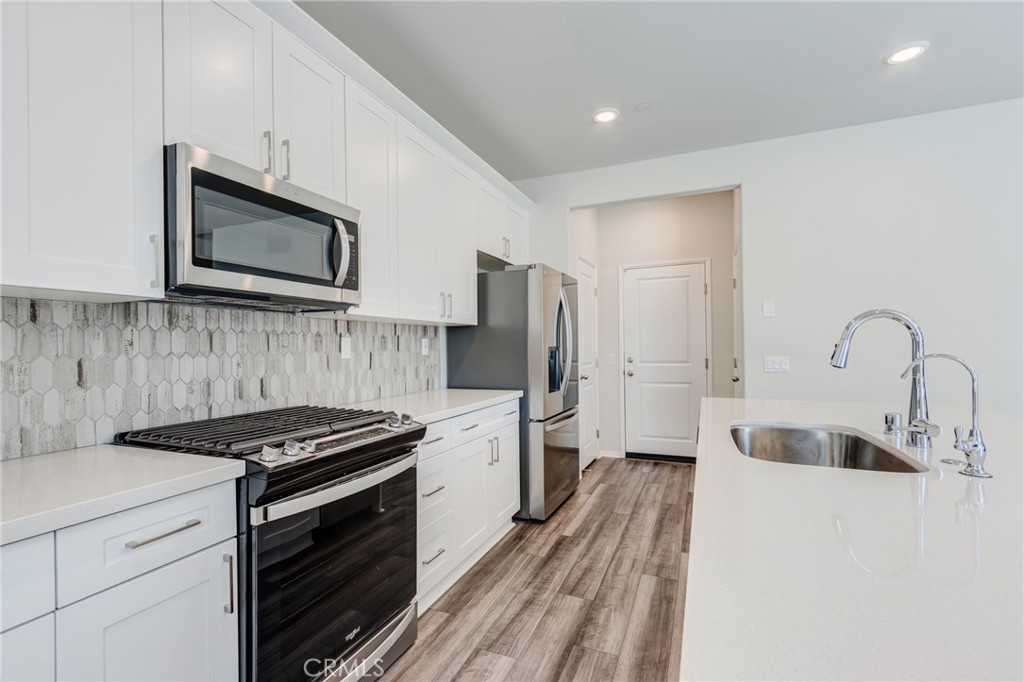 36469 Shine Drive Winchester, CA 92596 - Photo 9 of 73 a kitchen with stainless steel appliances a stove sink and refrigerator