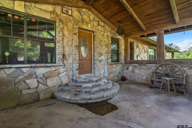 a living room with furniture a large window and a flat screen tv