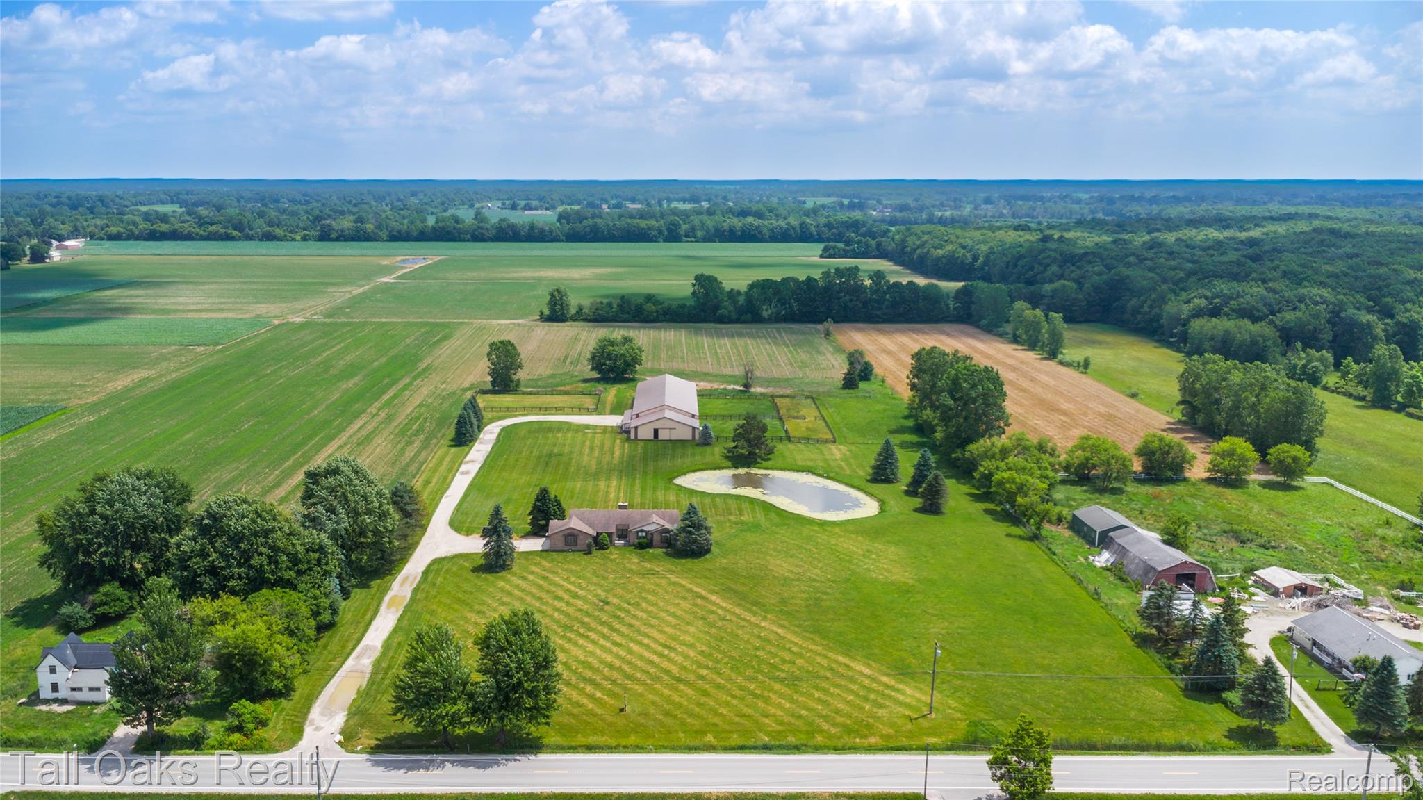 79330 Capac Road Armada, MI 48005 - Photo 1 of 42 Expansive rural property featuring multiple structures, a private pond, and manicured green spaces
