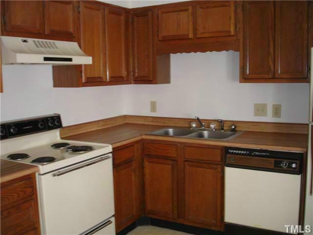 200-210 North Hollybrook Road Wendell, NC 27591 - Photo 3 of 4 a kitchen with a stove and a white cabinets