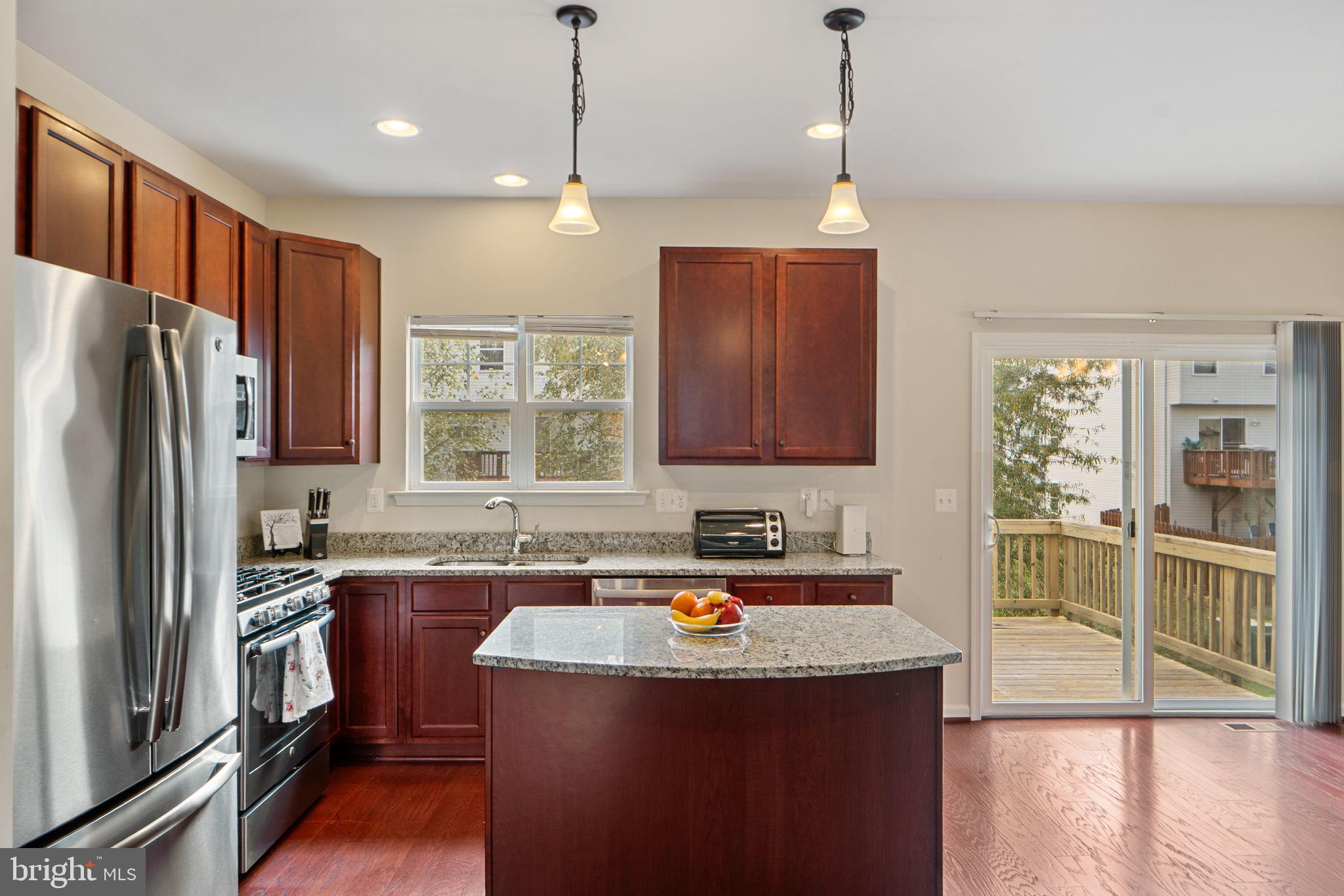 2210 Mallard Landing Drive Fredericksburg, VA 22408 - Photo 11 of 30 a kitchen with stainless steel appliances granite countertop a refrigerator a sink dishwasher a stove and white countertops with wooden floor