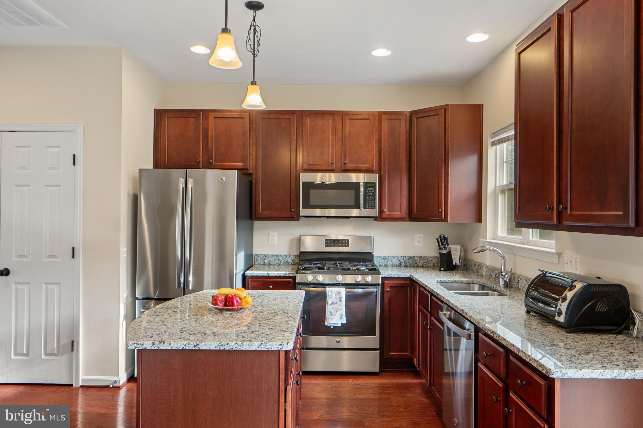 2210 Mallard Landing Drive Fredericksburg, VA 22408 - Photo 13 of 30 a kitchen with stainless steel appliances granite countertop a stove refrigerator sink and microwave