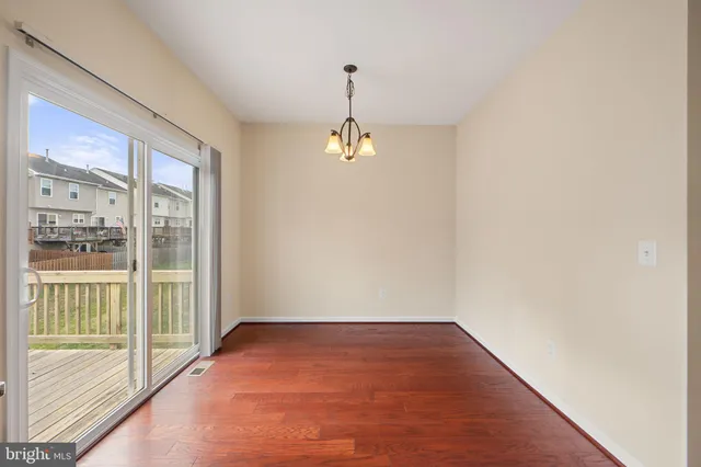 a view of a room with wooden floor and windows