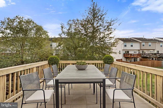 a view of a chairs and table on the balcony